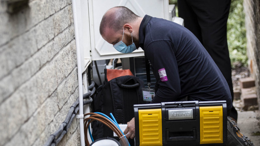 Kneeling down to install a smart meter during covid